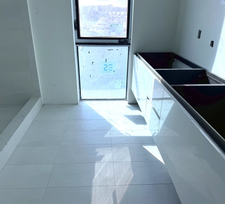 Bathroom under construction with tiled shower and unfinished vanity