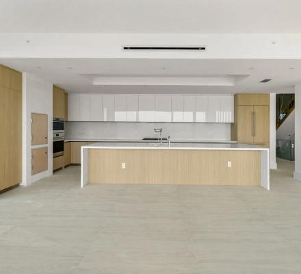 Modern kitchen with long island and white cabinet wall
