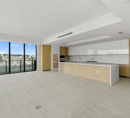 Straight-on modern kitchen with long island and wood cabinetry
