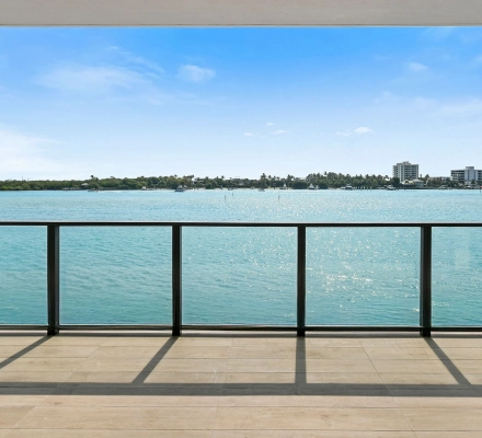 Wide balcony railing view across blue waterfront