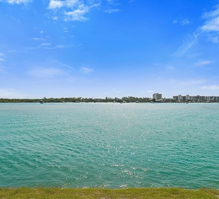 Cropped waterfront view with turquoise water, boat, and marina