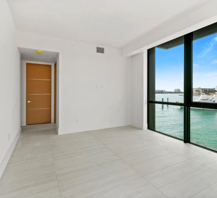 Balcony connected to empty condo interior through sliding doors