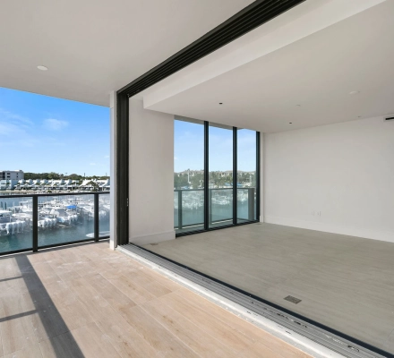 Balcony beside empty room overlooking marina slips