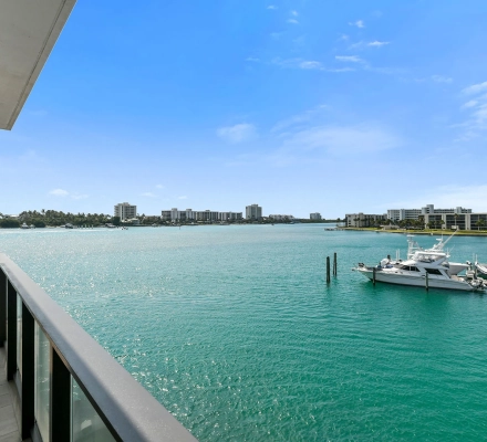 Balcony railing overlooking marina channel and boats