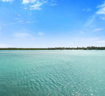 Wide open turquoise water view with distant shoreline