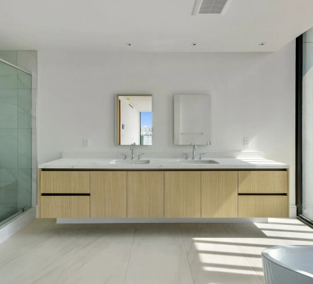 Modern bathroom with double vanity and glass shower