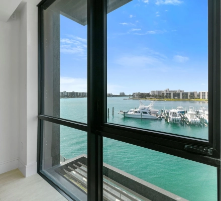 Window close-up overlooking yacht and marina boats