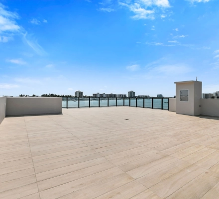 Rooftop terrace with utility structure and marina view